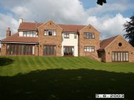 Arts and Crafts house extended at rear overlooking local golf course